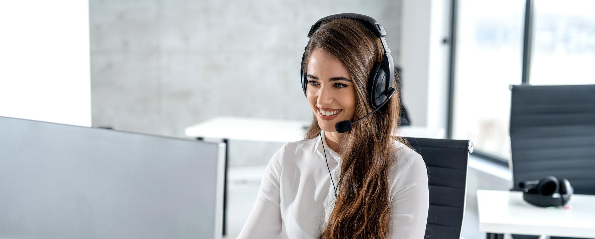 Service desk operator wearing a headset, the human escalation point that decides whether a chatbot deployment survives its first year